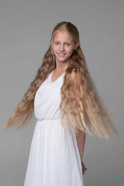 Young beautiful girl posing in white dress — Stock Photo, Image