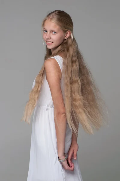 Young beautiful girl posing in white dress — Stock Photo, Image