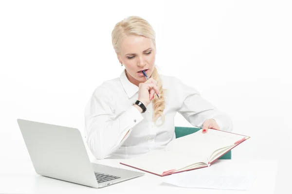 Thoughtful businesswoman writing on datebook — Stock Photo, Image