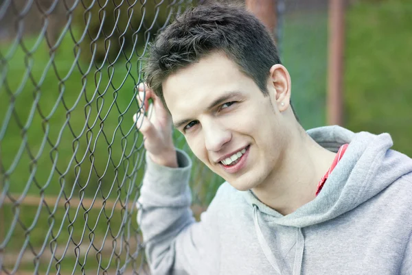 Street man close to fence — Stock Photo, Image