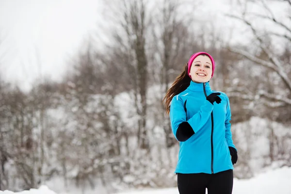 Woman running in winter Royalty Free Stock Images