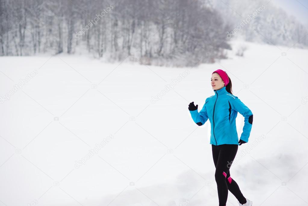 Woman running in winter Stock Photo by ©halfpoint 31758559