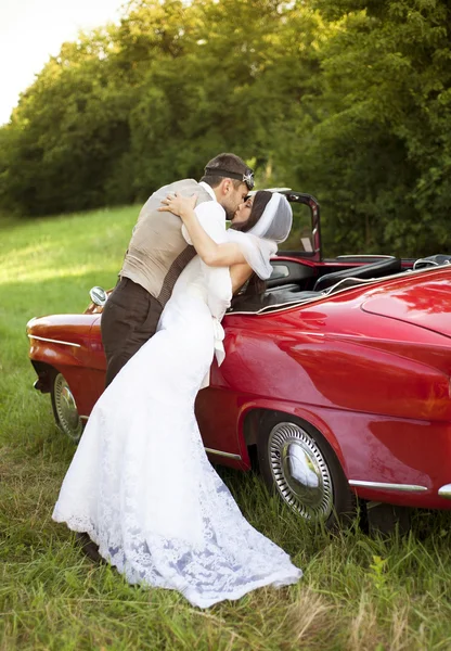 Svatební auto s nevěstou a ženichem — Stock fotografie