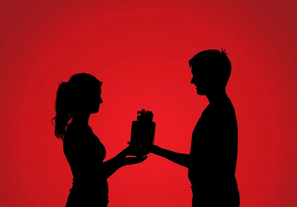 Silhouettes de couple avec cadeau — Photo