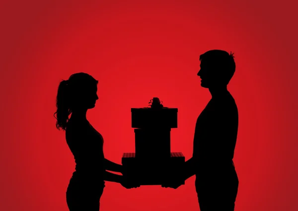 Silhouetten von Paar mit Geschenk — Stockfoto