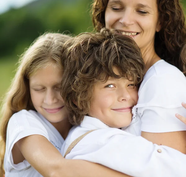 Children and mother hugging — Stock Photo, Image