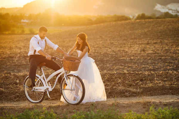 Bride and groom with a white wedding bike — Stock Photo, Image