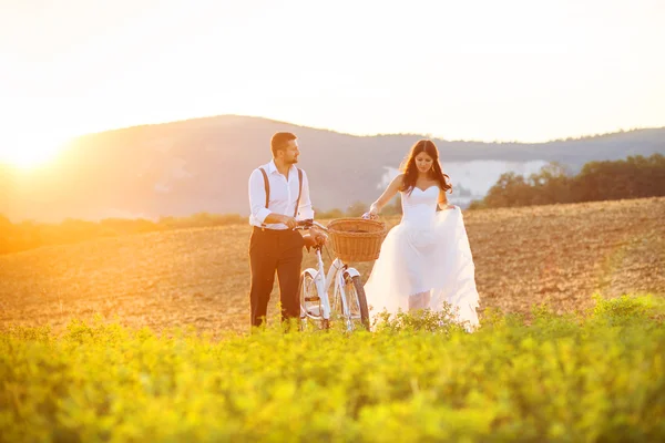 Жених и невеста с белым свадебным велосипедом — стоковое фото