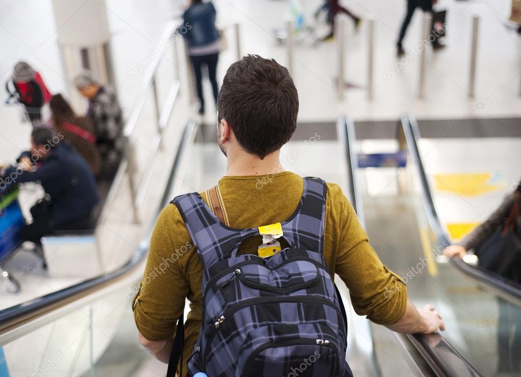 Young man at the airport is going for holiday