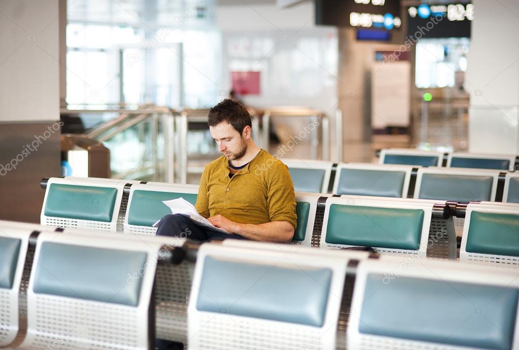 Young man using a tablet at airport