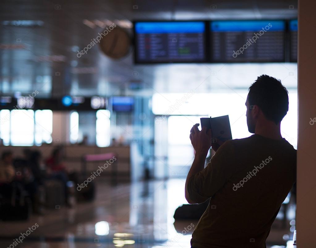 Young man at the airport is going for holiday