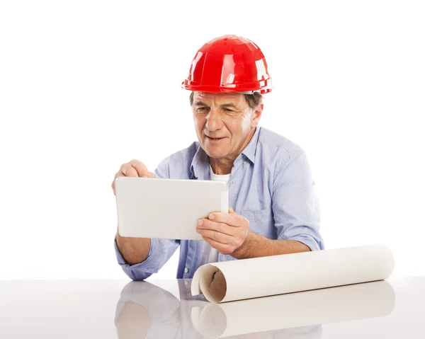 Engineer using digital tablet and plans — Stock Photo, Image