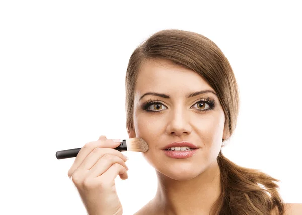 Woman putting makeup on herself — Stock Photo, Image