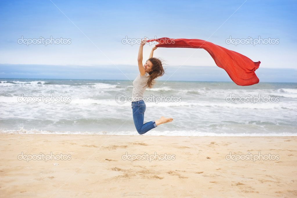 Sport woman jumping at the beach.