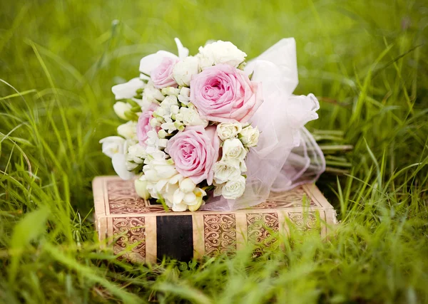 Wedding bouquet on the book — Stock Photo, Image