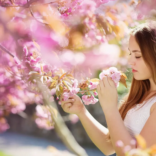 Flicka att lukta blommor — Stockfoto