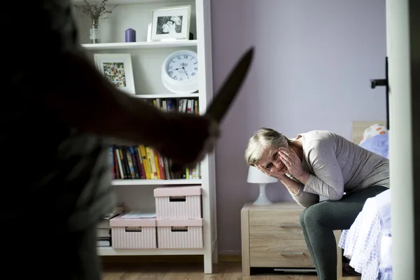 Woman scared of man with knife — Stock Photo, Image