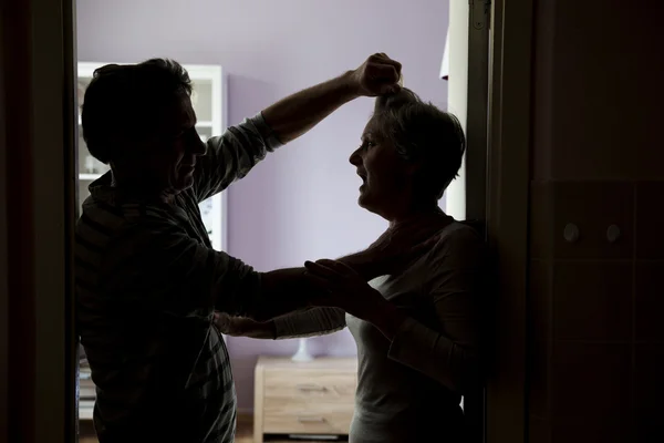 Silhouette of mature couple fighting