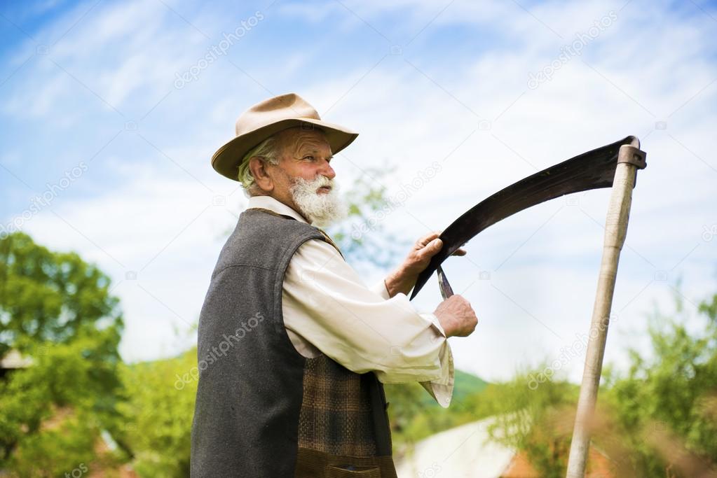 Farmer sharpening his scythe