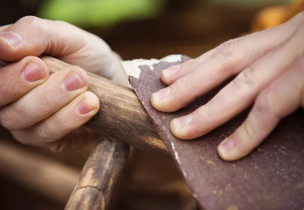 Male hands removing paint from chair — Stock Image Male hands removing paint from chair Stock Picture