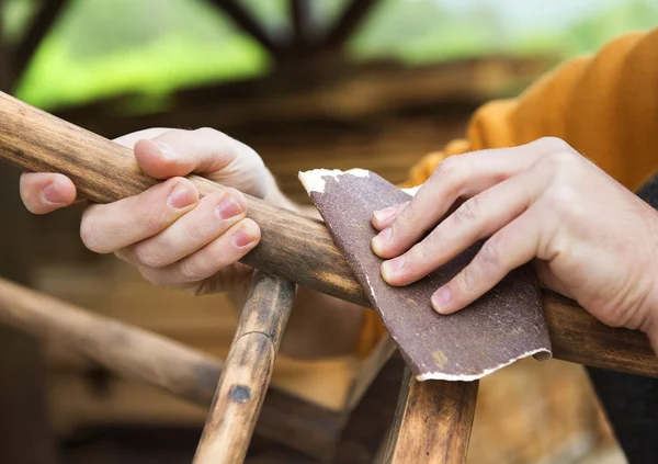 Male hands removing paint from chair — Stock Image Male hands removing paint from chair Royalty Free Stock Photos