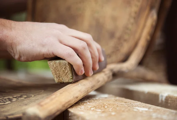 Male hands removing paint from chair — Stock Image Male hands removing paint from chair Stock Image