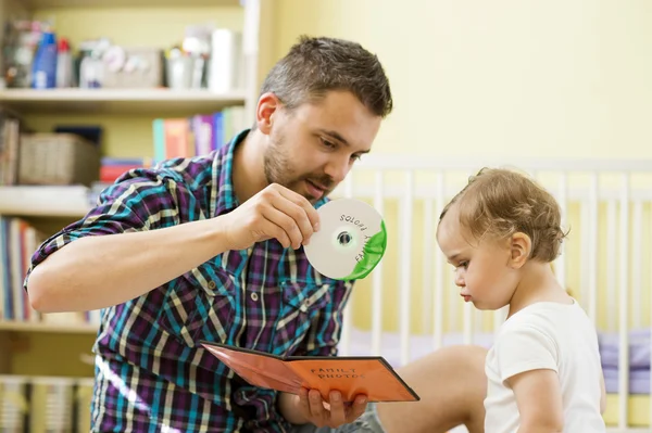 Father showing CD for daughter — Stock Photo, Image