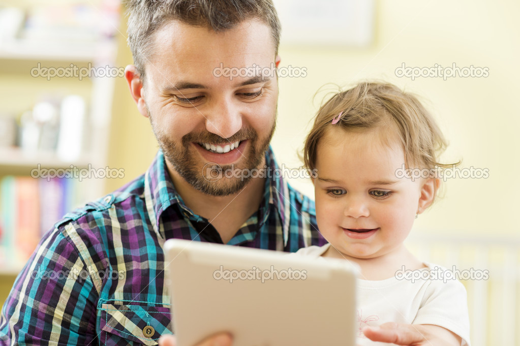 Father and daughter using digital tablet