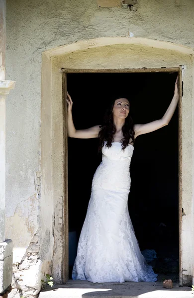 Bride posing by old house — Stock Photo, Image