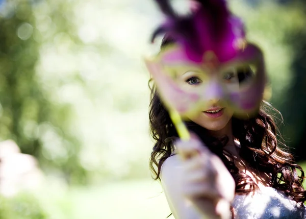 Bride with mask at meadow — Stock Photo, Image