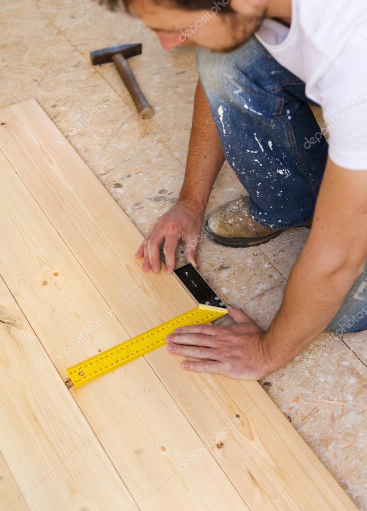 Measuring Wood Flooring Stock Photo Halfpoint 47909163 Close Up Of Male Hands Measuring Wood Flooring Photo By Halfpoint