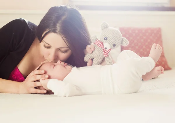 Mother kissing her baby — Stock Photo, Image