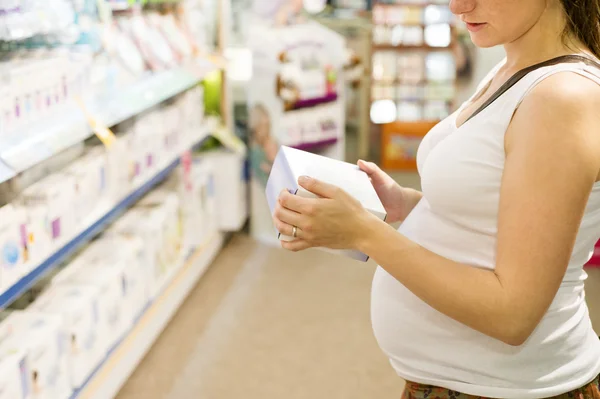 Woman choosing baby stuff — Stock Photo, Image