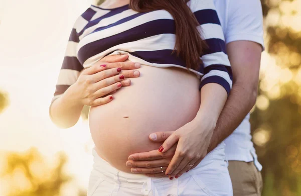 Hands holding pregnant belly — Stock Photo, Image