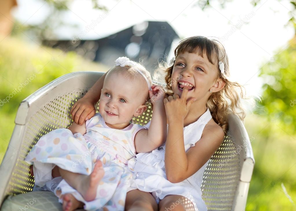 Little sisters in sunny park