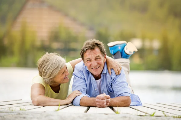 Senior couple having fun on pier — Stock Photo, Image