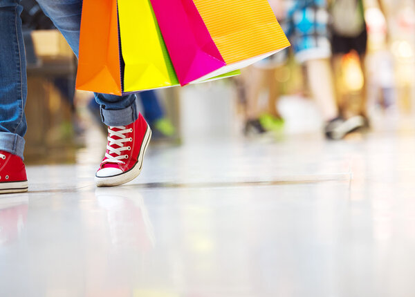 Female legs with shopping bags