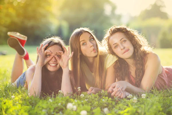 Girls and lying on grass — Stock Photo, Image