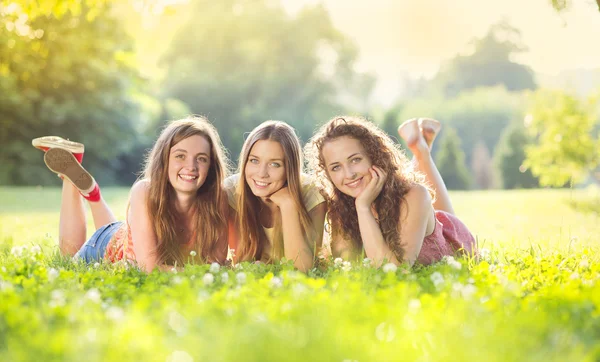 Girls and lying on grass Royalty Free Stock Photos