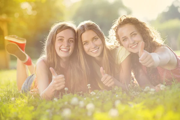 Girls and lying on grass Stock Image