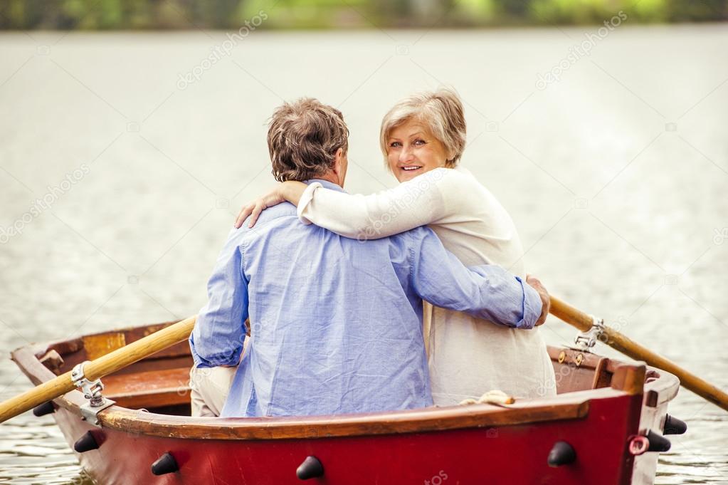 Senior couple paddling on boat