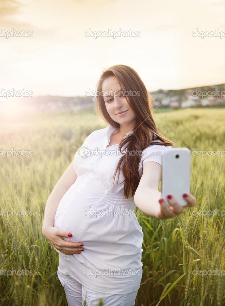 Pregnant woman taking selfie