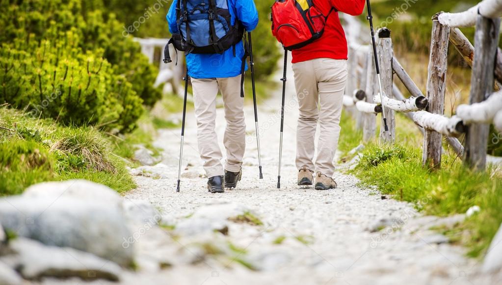 Legs of couple hiking at mountains