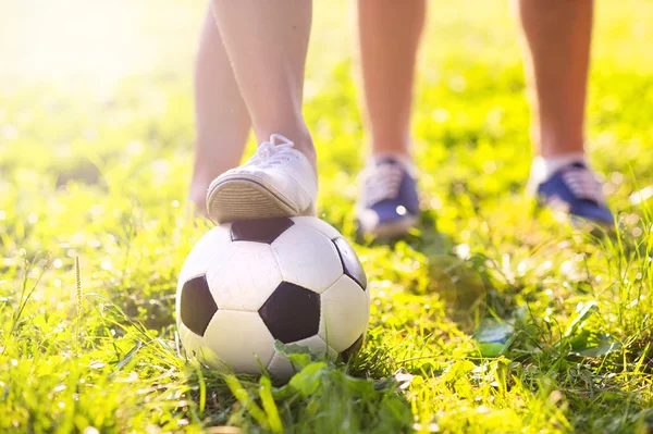 Nohy a fotbalový míč — Stock fotografie