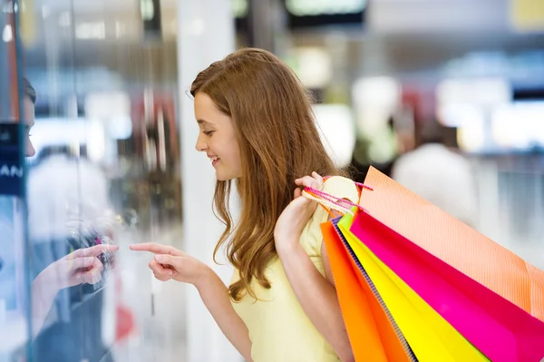 Girl with bags in shopping mall — Stock Photo, Image