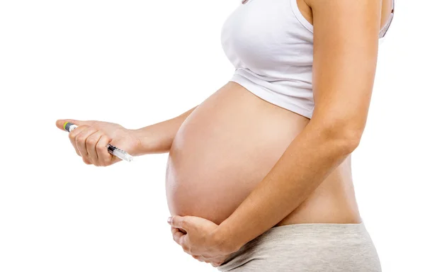 Pregnant woman with syringe in hand — Stock Photo, Image