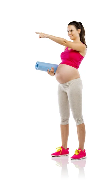 Pregnant woman holding mat — Stock Photo, Image