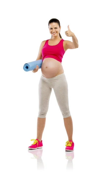 Pregnant woman holding mat — Stock Photo, Image