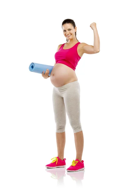 Zwangere vrouw bedrijf mat — Stockfoto