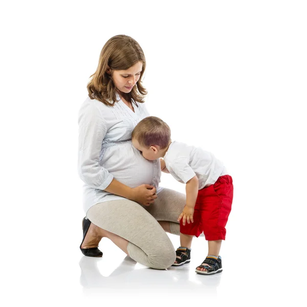 Mother with son kissing her belly — Stock Photo, Image